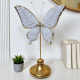 Стилна декоративна статуетка на бяла пеперуда със златни акценти на крилете.
