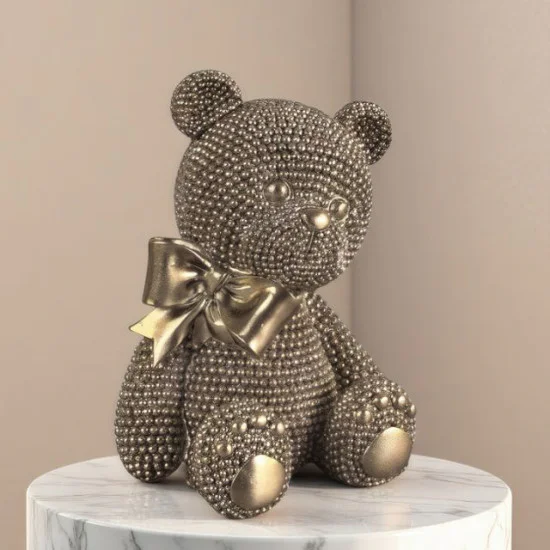 Нежна декоративна статуетка златисто мече с панделка